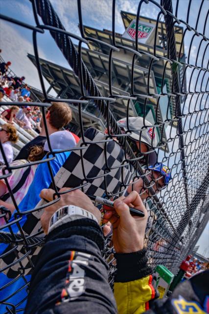 Simon Pagenaud signs an autograph along pit lane prior to qualifications for the 102nd Indianapolis 500 at the Indianapolis Motor Speedway -- Photo by: Doug Mathews
