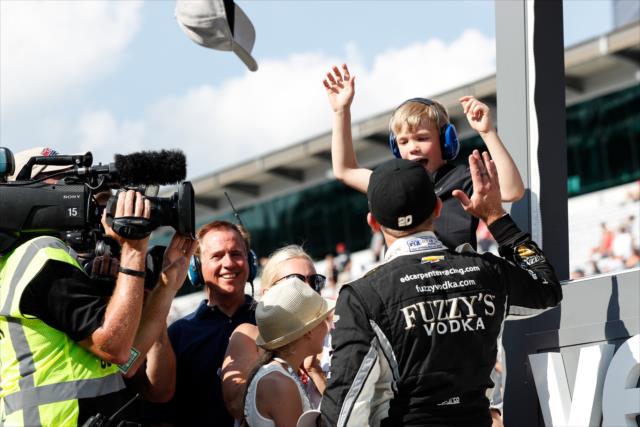 Ed Carpenter celebrates with his family on pit lane after winning the pole position for the 102nd Indianapolis 500 at the Indianapolis Motor Speedway -- Photo by: Joe Skibinski