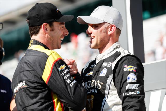 Simon Pagenaud congratulates Ed Carpenter on pit lane after winning the pole position for the 102nd Indianapolis 500 at the Indianapolis Motor Speedway -- Photo by: Joe Skibinski
