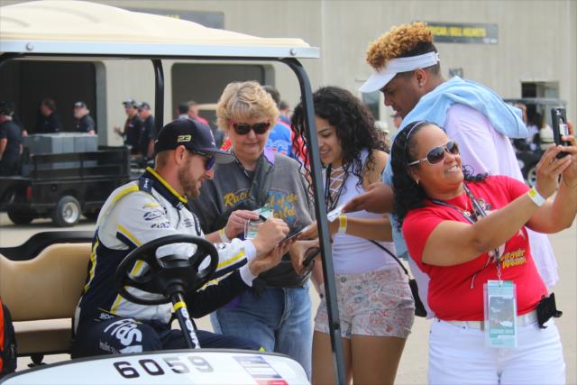 Charlie Kimball signs an autograph in Gasoline Alley prior to qualifications for the 102nd Indianapolis 500 at the Indianapolis Motor Speedway -- Photo by: Mike Harding