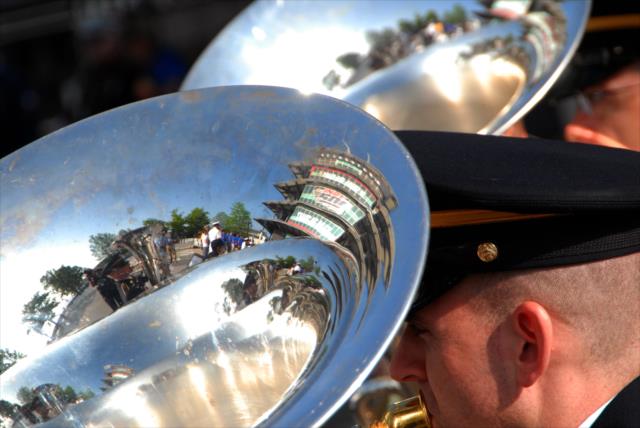 The shine of a 38th Infantry Division Band member's tuba reflects the iconic Indianapolis Motor Speedway Pagoda during Sunday morning's enlistment ceremony -- Photo by: Mike Young