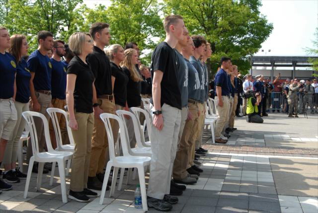 Enlisting cadets stand at attention during the enlistment ceremony at the Indianapolis Motor Speedway. -- Photo by: Mike Young