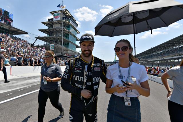 James Hinchcliffe and his girlfriend, Becky, walk pit lane during the 2018 pit stop competition on Miller Lite Carb Day at the Indianapolis Motor Speedway -- Photo by: John Cote