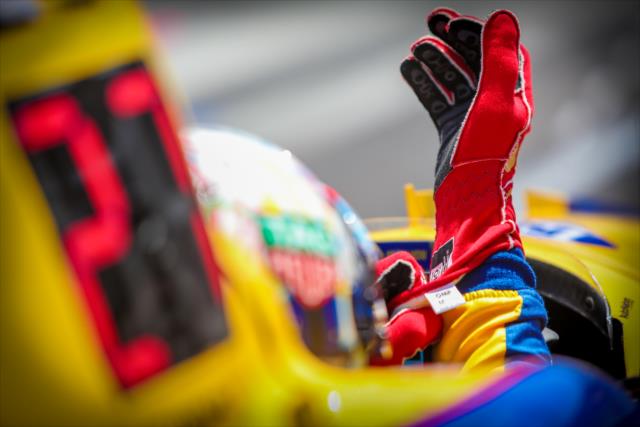 Alexander Rossi adjusts the gloves on pit lane prior to the final practice on Miller Lite Carb Day at the Indianapolis Motor Speedway -- Photo by: Shawn Gritzmacher