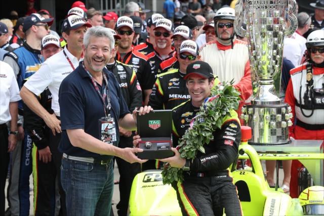 Simon Pagenaud receives a Tag Heuer watch in Victory Lane after winning the 103rd Running of the Indianapolis 500 presented by Gainbridge -- Photo by: Chris Jones