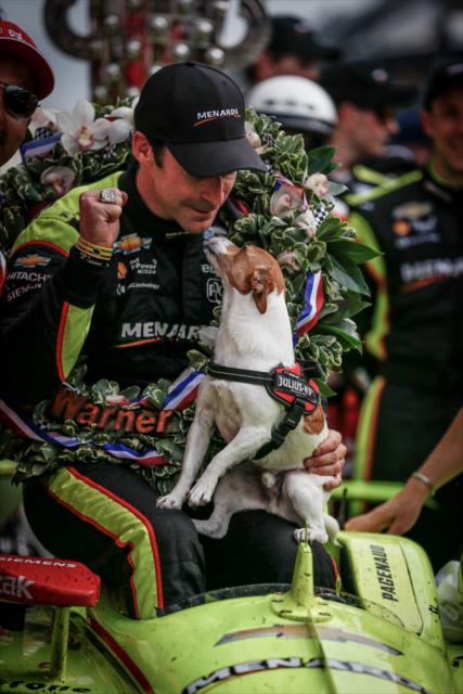 Simon Pagenaud celebrates with his dog, Norman, in Victory Circle after winning the 103rd Running of the Indianapolis 500 presented by Gainbridge -- Photo by: Shawn Gritzmacher