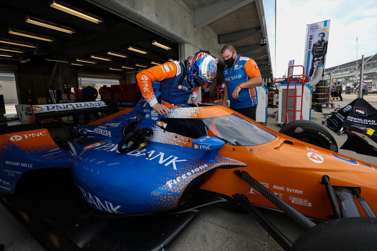 Scott Dixon slides into his No. 9 PNC Bank Honda in the paddock area prior to practice for the GMR Grand Prix on the Indianapolis Motor Speedway Road Course -- Photo by: Chris Owens
