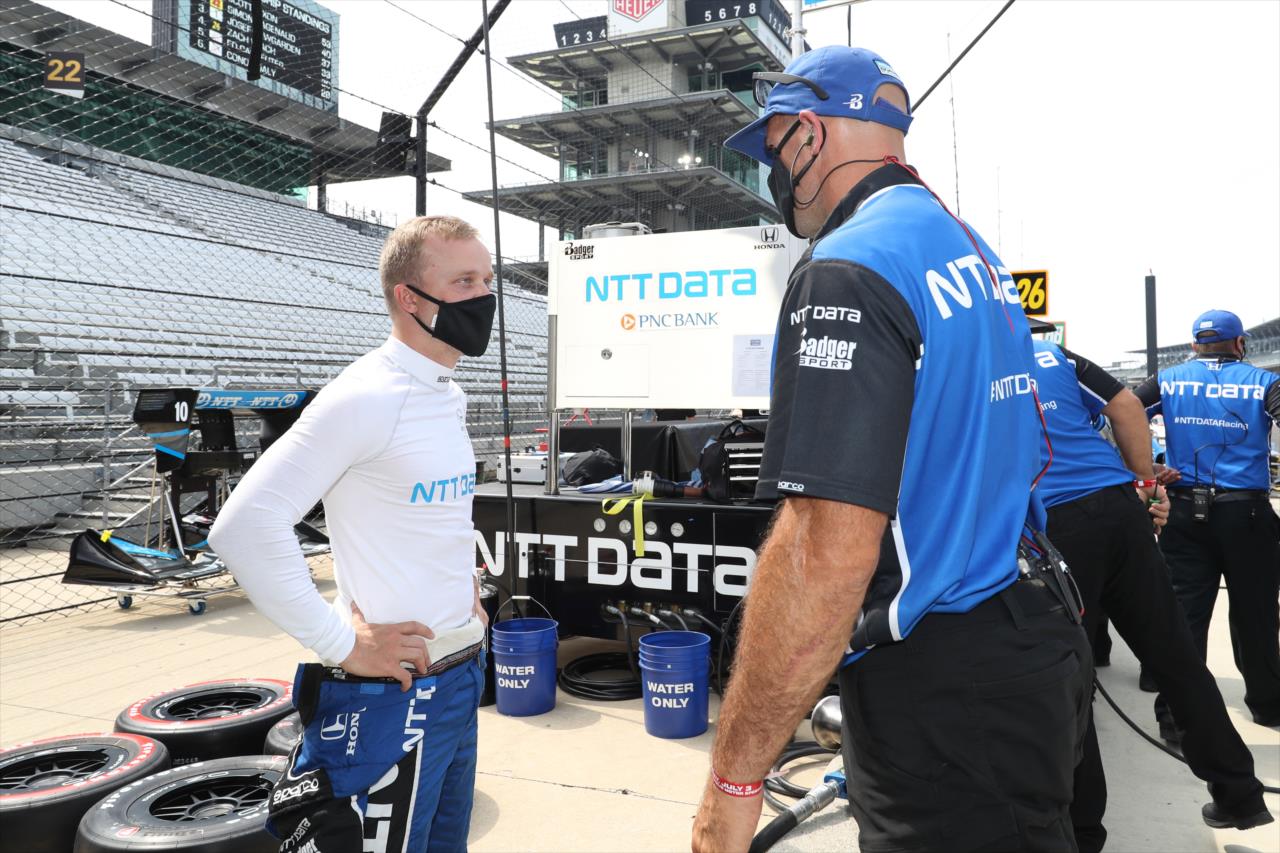 Felix Rosenqvist chats with a team member on pit lane prior to practice for the GMR Grand Prix on the Indianapolis Motor Speedway Road Course -- Photo by: Chris Owens