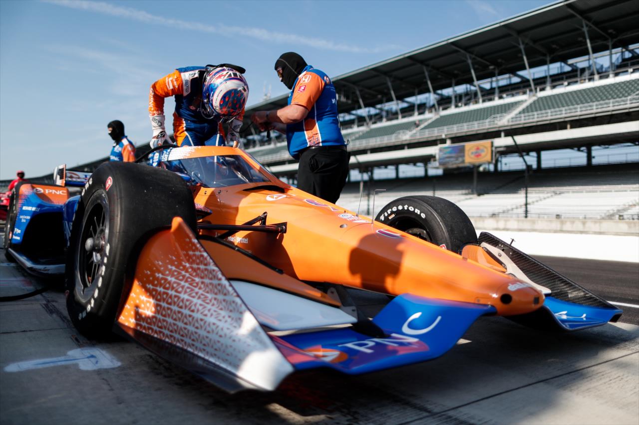 Scott Dixon slides into his No. 9 PNC Bank Honda on pit lane prior to the start of the final warmup for the 2020 GMR Grand Prix at the Indianapolis Motor Speedway -- Photo by: Joe Skibinski