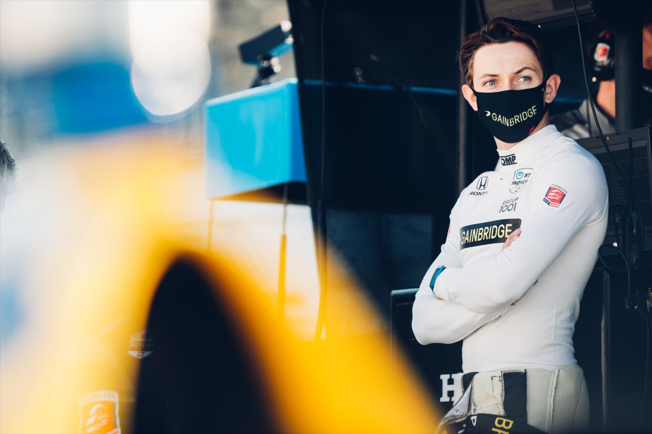 Zach Veach looks down pit lane from his stand prior to the start of the final warmup for the 2020 GMR Grand Prix at the Indianapolis Motor Speedway -- Photo by: Joe Skibinski