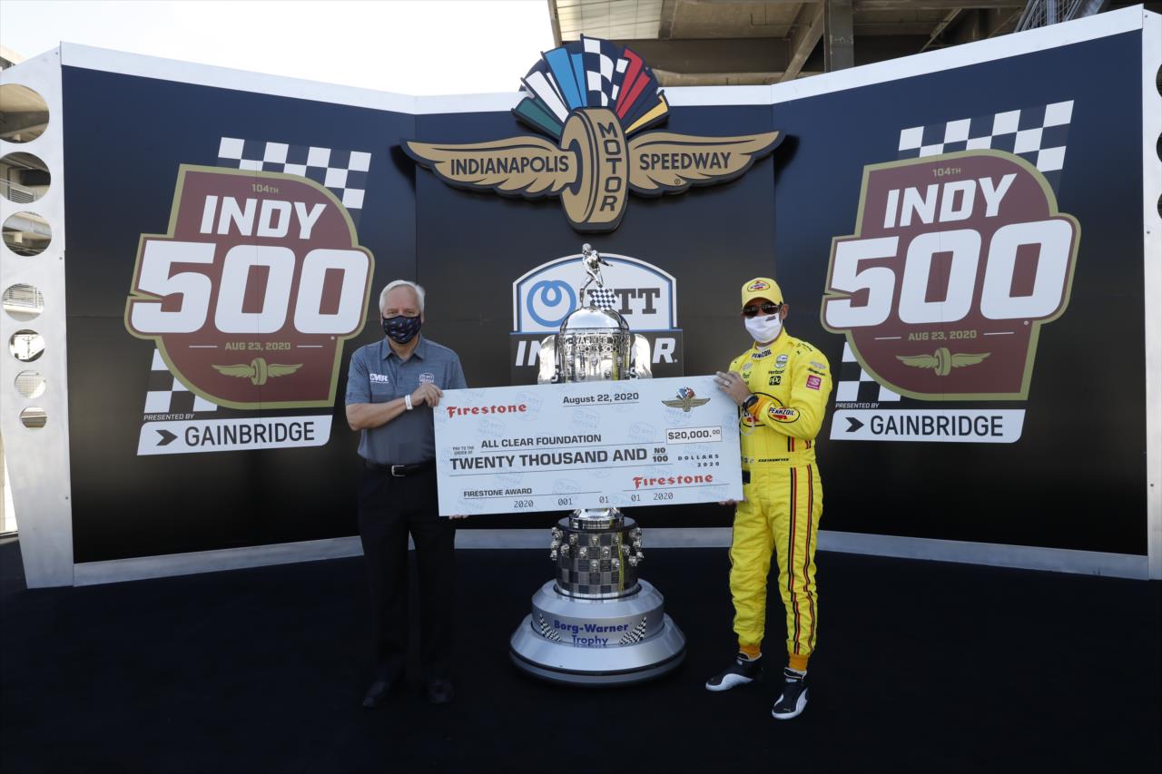 Helio Castroneves presents check from Firestone to All Clear Foundation on Indianapolis 500 Miller Lite Carb Day at the Indianapolis Motor Speedway Friday, August 21, 2020 -- Photo by: Chris Jones
