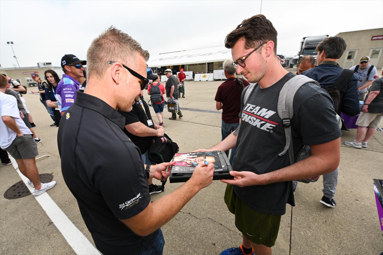 Ed Carpenter signs and autograph for a fan - By: James Black -- Photo by: James  Black