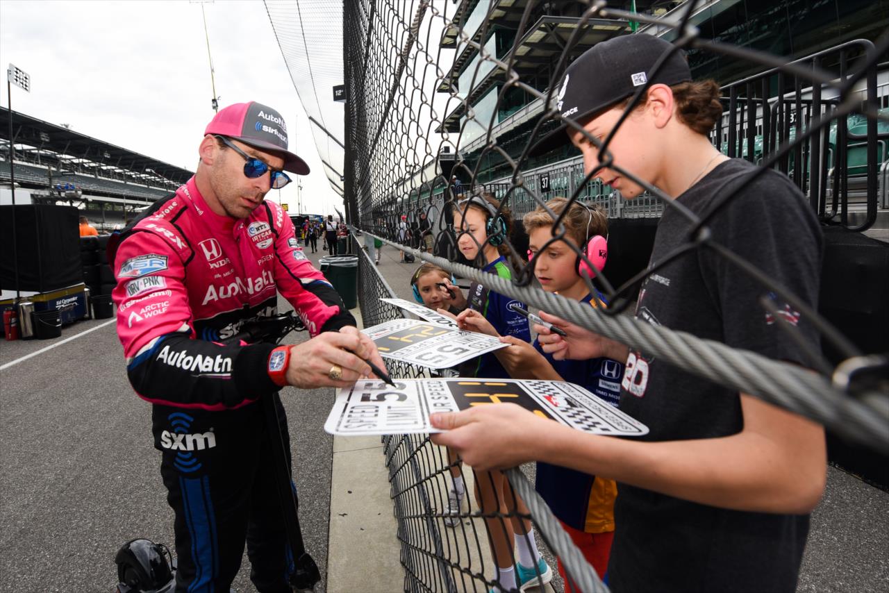 Simon Pagenaud signs an autograph for a fan - Indianapolis 500 Practice - By: James Black -- Photo by: James  Black