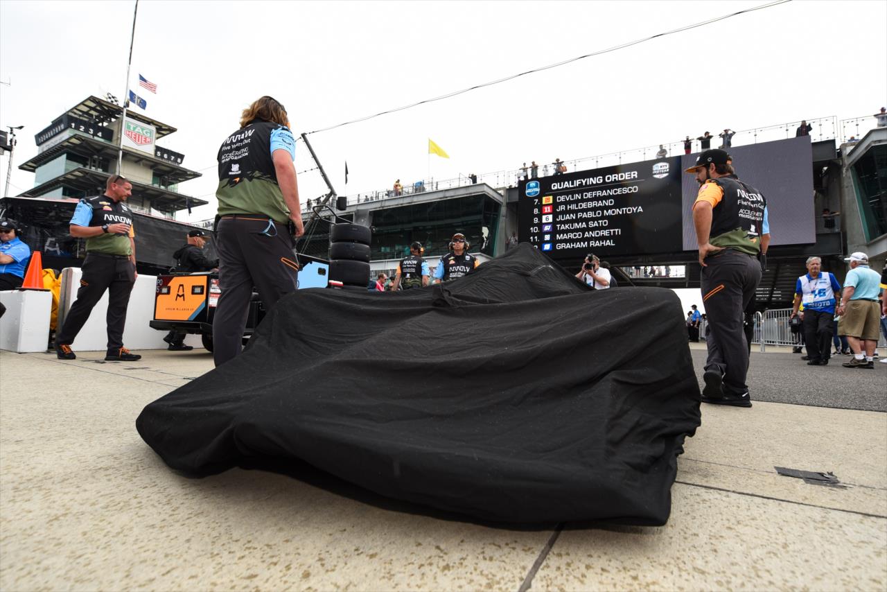 A rain cover on a car in Gasoline Alley - PPG Presents Armed Forces Qualifying - By: James Black -- Photo by: James  Black