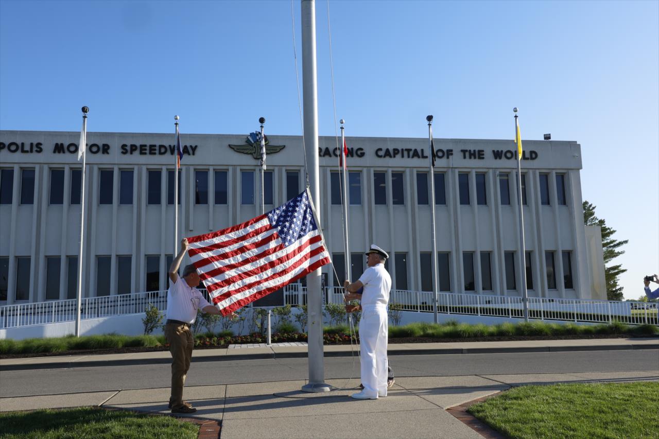 U.S. Navy Vice Adm. Sean Buck raises a flag from the USS Indianapolis - Legends Day Presented by Firestone - By: Chris Jones -- Photo by: Chris Jones
