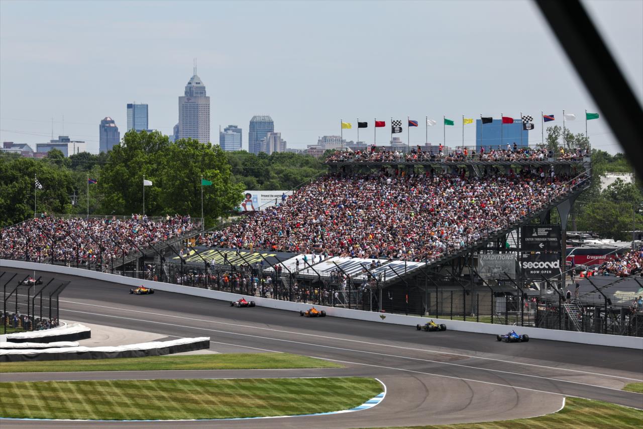 Field streams toward Turn 2 - 107th Running of the Indianapolis 500 Presented By Gainbridge - By: Chris Owens -- Photo by: Chris Owens