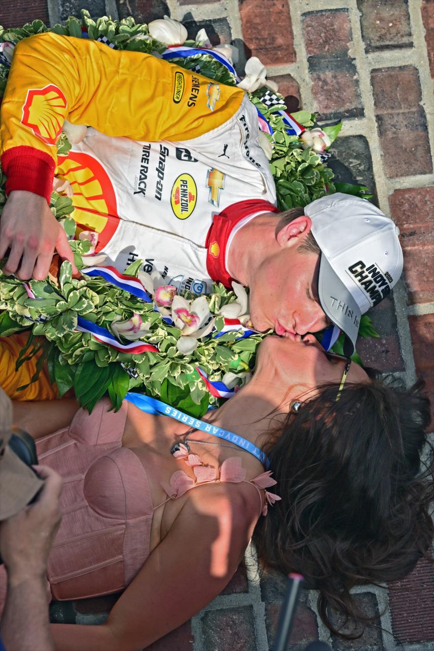 Josef Newgarden and wife, Ashley, kiss on the Yard of Bricks - 107th Running of the Indianapolis 500 Presented By Gainbridge - By: Walt Kuhn -- Photo by: Walt Kuhn