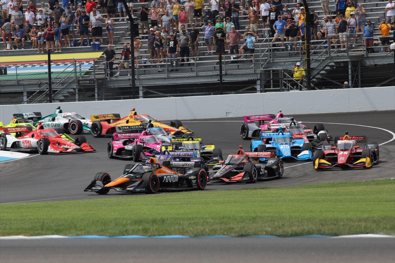 The NTT INDYCAR SERIES field rushes towards Turn 2 on Lap 1 of the Big Machine Spiked Coolers Grand Prix at IMS on Saturday, Aug. 14. -- Photo by: Aaron Skillman