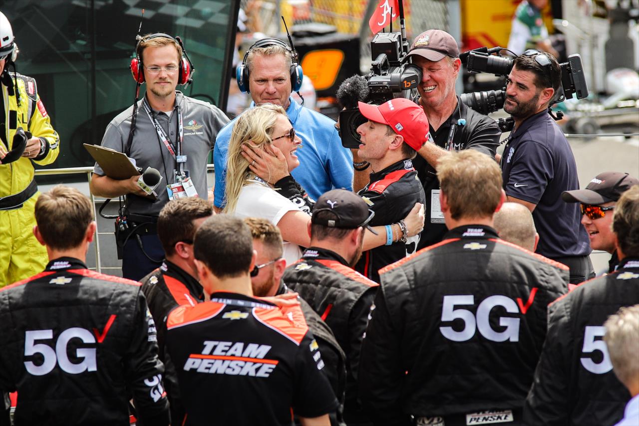 Will Power embraces his wife, Liz, on Victory Podium after winning the Big Machine Spiked Coolers Grand Prix Saturday, Aug. 14 at IMS. -- Photo by: Aaron Skillman