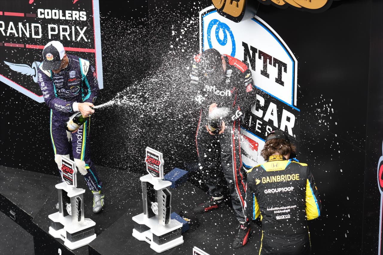 From left, podium finishers Romain Grosjean, Will Power and Colton Herta celebrate with champagne after the Big Machine Spiked Coolers Grand Prix at IMS on Saturday, Aug. 14. -- Photo by: James  Black