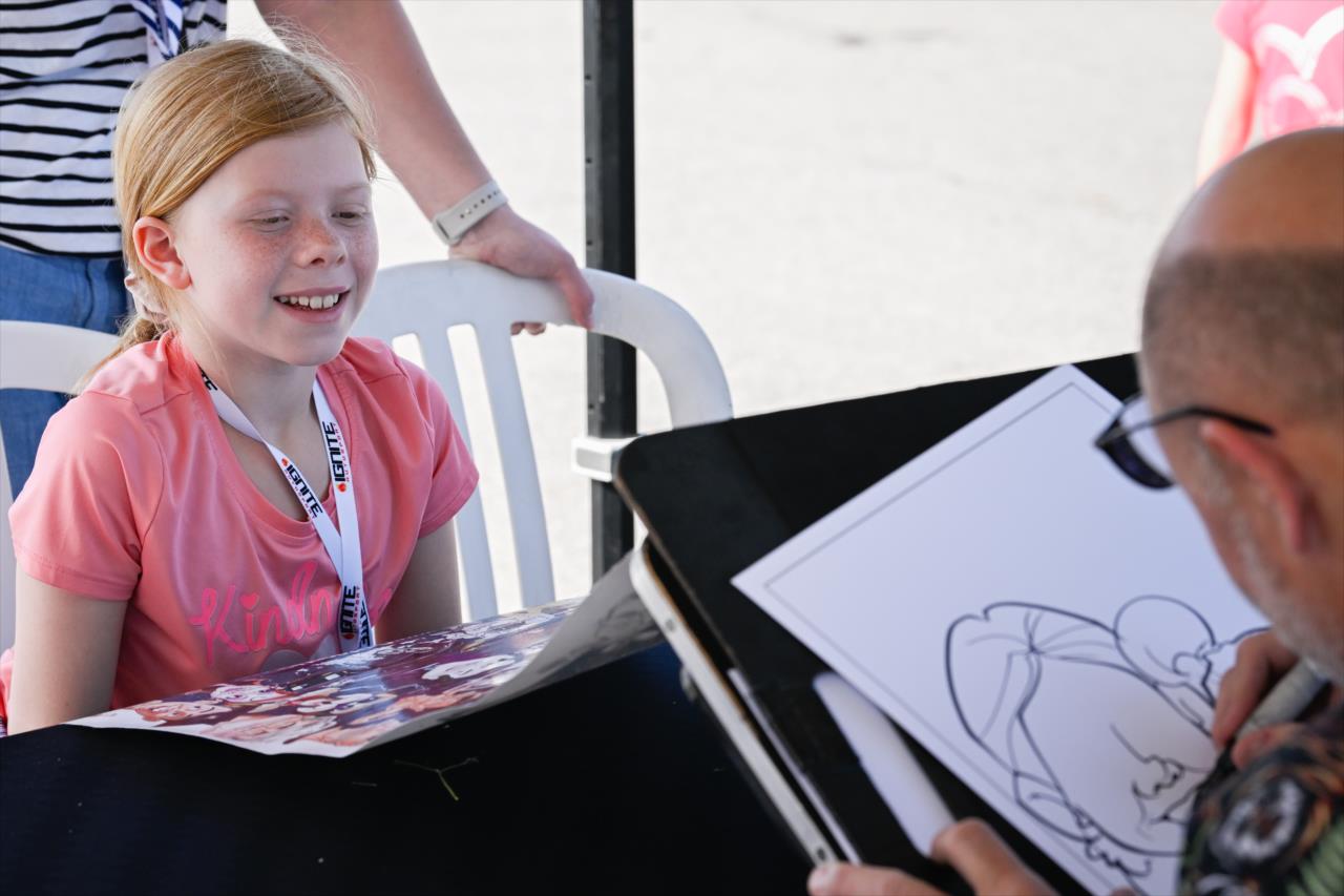 Young fan has a caricature drawn in the Kid Zone - By: Karl Zemlin -- Photo by: Karl Zemlin