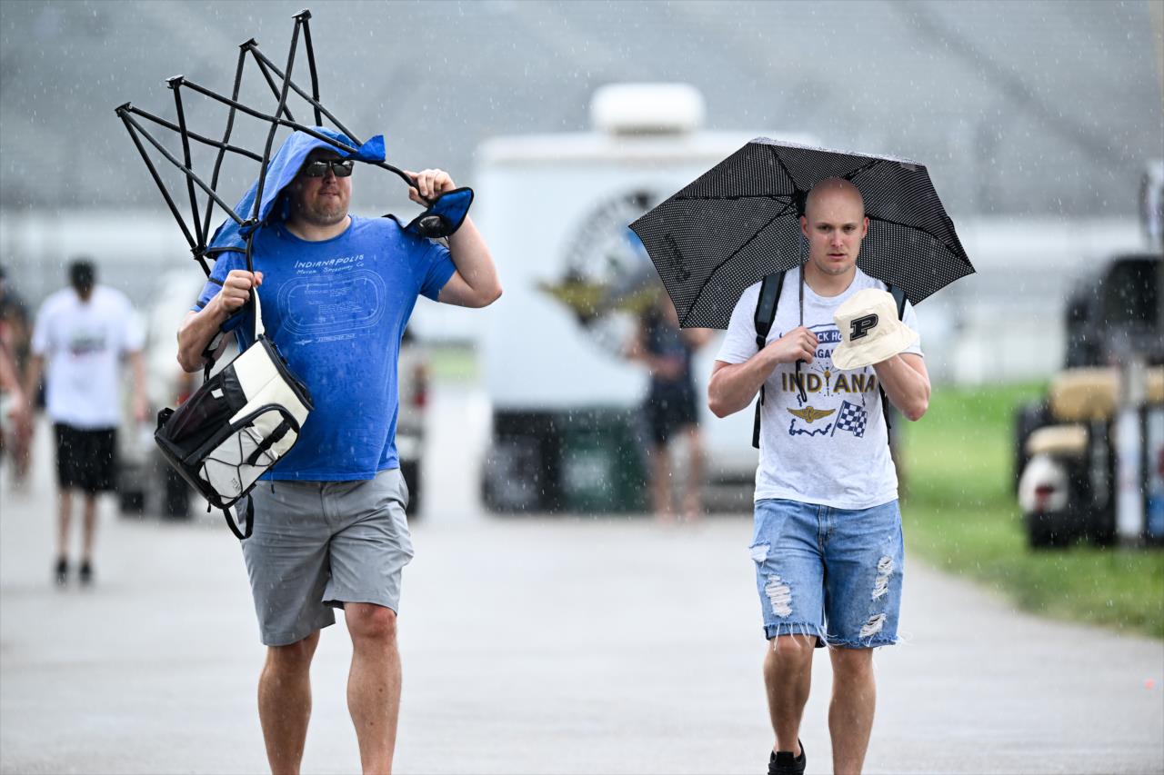 Fans seek protection from the rain before the GMR Grand Prix - By: Karl Zemlin -- Photo by: Karl Zemlin