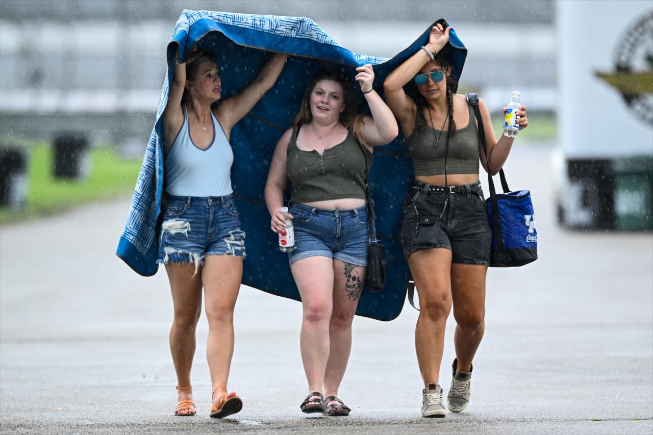 Fans seek protection from the rain before the GMR Grand Prix - By: Karl Zemlin -- Photo by: Karl Zemlin