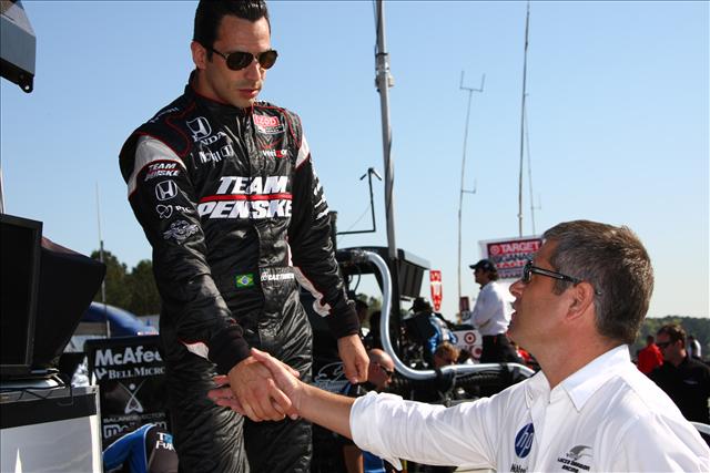 Helio Castroneves shakes hands with former teammate and new team owner Gil de Ferran. -- Photo by: Dan Helrigel