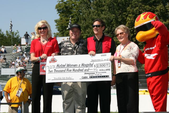 Hutzel Women's Hospital gets a check from CARA Charities before the Detroit Indy Grand Prix on Race day. -- Photo by: Chris Jones