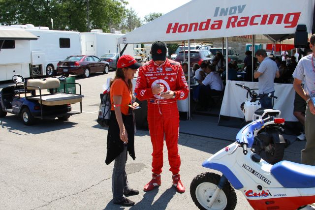 Scott Dixon signs an autograph for a fan before the Detroit Indy Grand Prix on Race day. -- Photo by: Shawn Payne