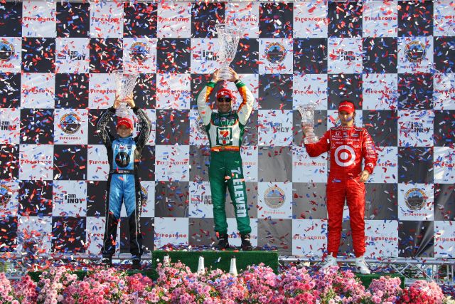 Podium finishers Danica Patrick, Tony Kanaan & Dan Wheldon hold trophies high as confetti flies. -- Photo by: Shawn Payne