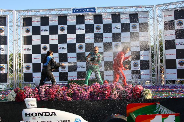 Champagne shoot-out with podium finishers Danica Patrick, Tony Kanaan & Dan Wheldon. -- Photo by: Shawn Payne