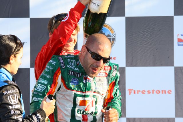 Race winner Tony Kanaan gets a champagne shower from third place finisher Dan Wheldon. -- Photo by: Shawn Payne