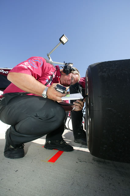 Pioneer Mo Nunn Racing crew member taking tire pressure readings -- Photo by: Ron McQueeney
