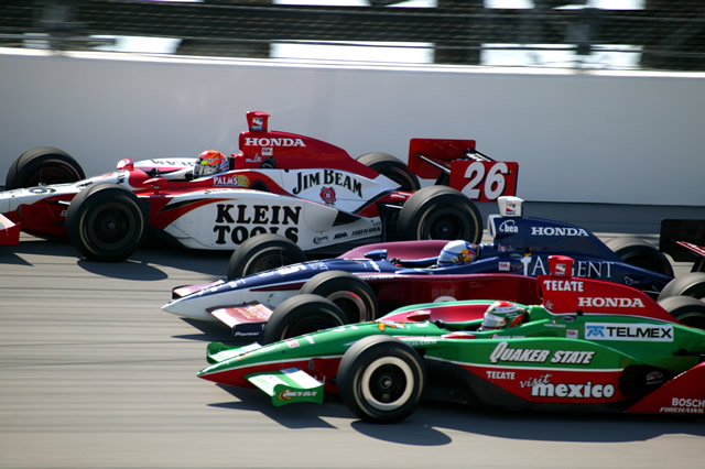 Race action between Adrian Fernandez, in the #5 Fernandez Racing, Buddy Rice, in the #15 Rahal-Letterman Racing, and Dan Wheldon, in the #26 Andretti Green Racing. -- Photo by: Shawn Payne