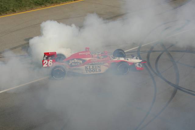 #26 Dan Wheldon celebrates with some donuts after winning the Peak Antifreeze Indy 300 from Chichagoland Speedway. -- Photo by: Ron McQueeney