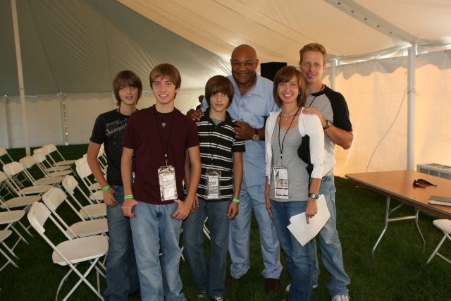 George Foreman poses with fans after the morning service at Chicagoland Speedway -- Photo by: Chris Jones