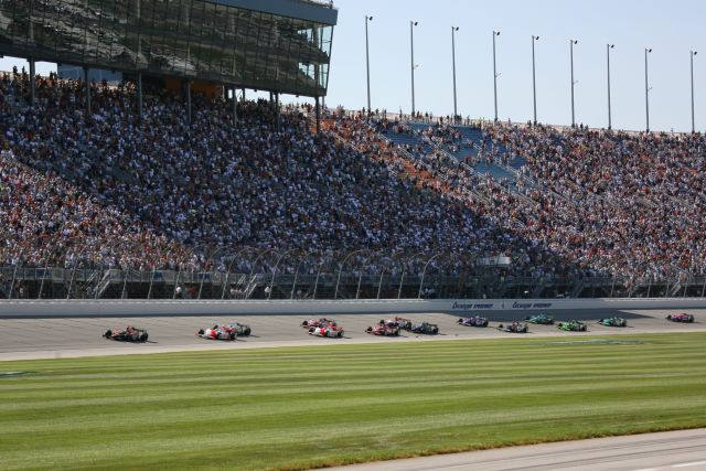 Chicagoland Speedway stands watch as the IndyCar Series field makes its way down front stretch. -- Photo by: Chris Jones