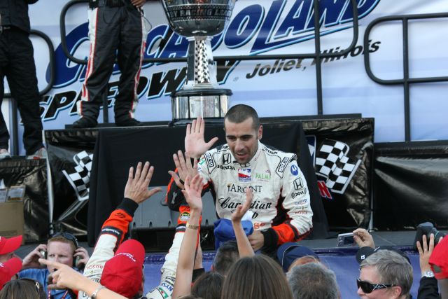 Race winner and series champion, Dario Franchitti, high-fives appreciative race fans. -- Photo by: Chris Jones