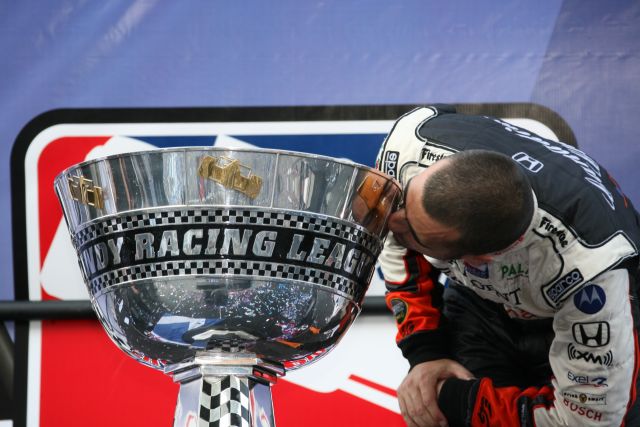 2007 IndyCar Series champion, Dario Franchitti plants one on the championship trophy. -- Photo by: Chris Jones
