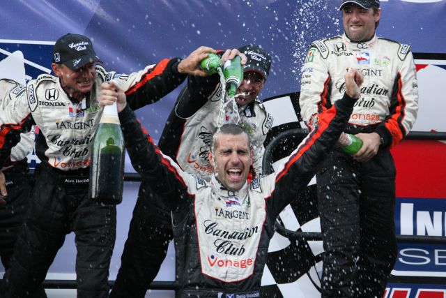 Dario Franchitti gets a champagne bath after winning the championship. -- Photo by: Dana Garrett