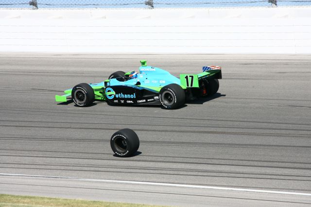 Rolling tire of #2 Tomas Scheckter makes its way towards infield as Rahal Letterman driver Ryan Hunter-Reay drives past. -- Photo by: Jim Haines