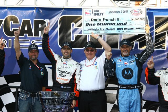 Dario Franchitti get a big check for his championship win. -- Photo by: Jim Haines