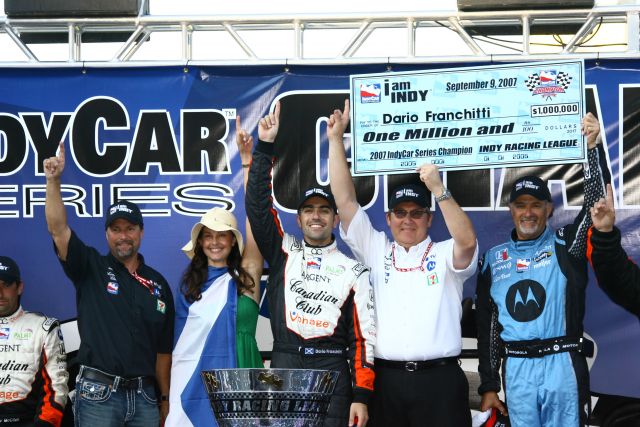 Race winner and IndyCar Series champion, Dario Franchitti, center, celebrates with team owners and wife Ashley Judd after winning the prized one million dollar purse. -- Photo by: Jim Haines