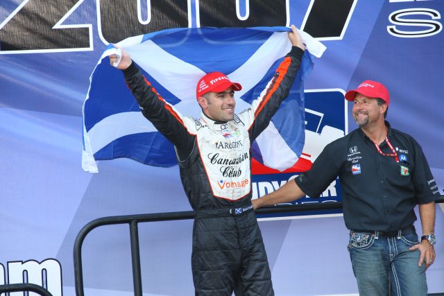 Race/Series winner Dario Franchitti shows his countries colors with team owner Michael Andretti. -- Photo by: Ron McQueeney