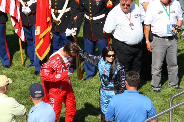 Target Chip Ganassi driver Dan Wheldon, left, is aided by AGR driver Danica Patrick prior to driver introductions. -- Photo by: Shawn Payne