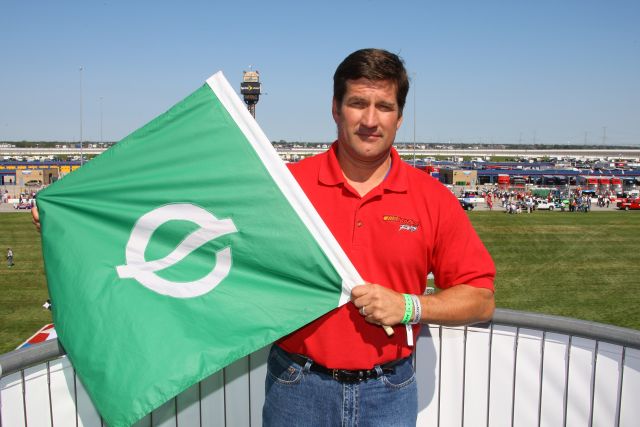 Honorary Starter, Bill Edwards, Director, Merchandising, AutoZone shows-off the Ethanol Green Flag used to start the Peak Antifreeze Indy 300 presented by Mr. Clean event at Chicagoland Speedway. -- Photo by: Shawn Payne