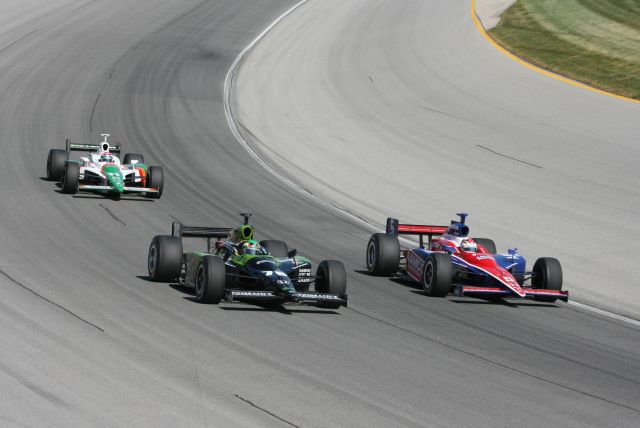 Roth Racing driver P.J. Chesson makes his way around Dreyer & Reinbold driver Sarah Fisher while AGR driver Tony Kanaan follows close behind. -- Photo by: Steve Snoddy
