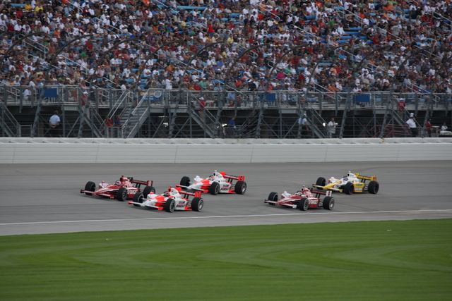 No. 10 Dan Wheldon and No. 3 Helio Castroneves run side by side during the PEAK Antifreeze & Motor Oil Indy 300 at Chicagoland Speedway. -- Photo by: Dana Garrett