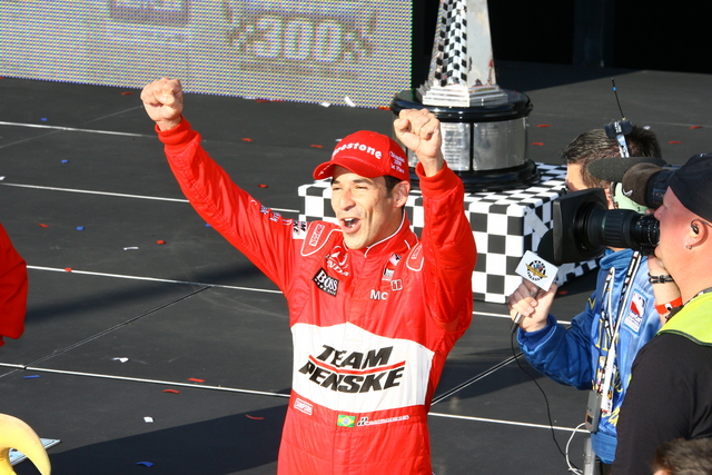 A jubilant Helio Castroneves celebrates winning the PEAK Antifreeze & Motor Oil Indy 300 at Chicagoland Speedway. -- Photo by: Jim Haines
